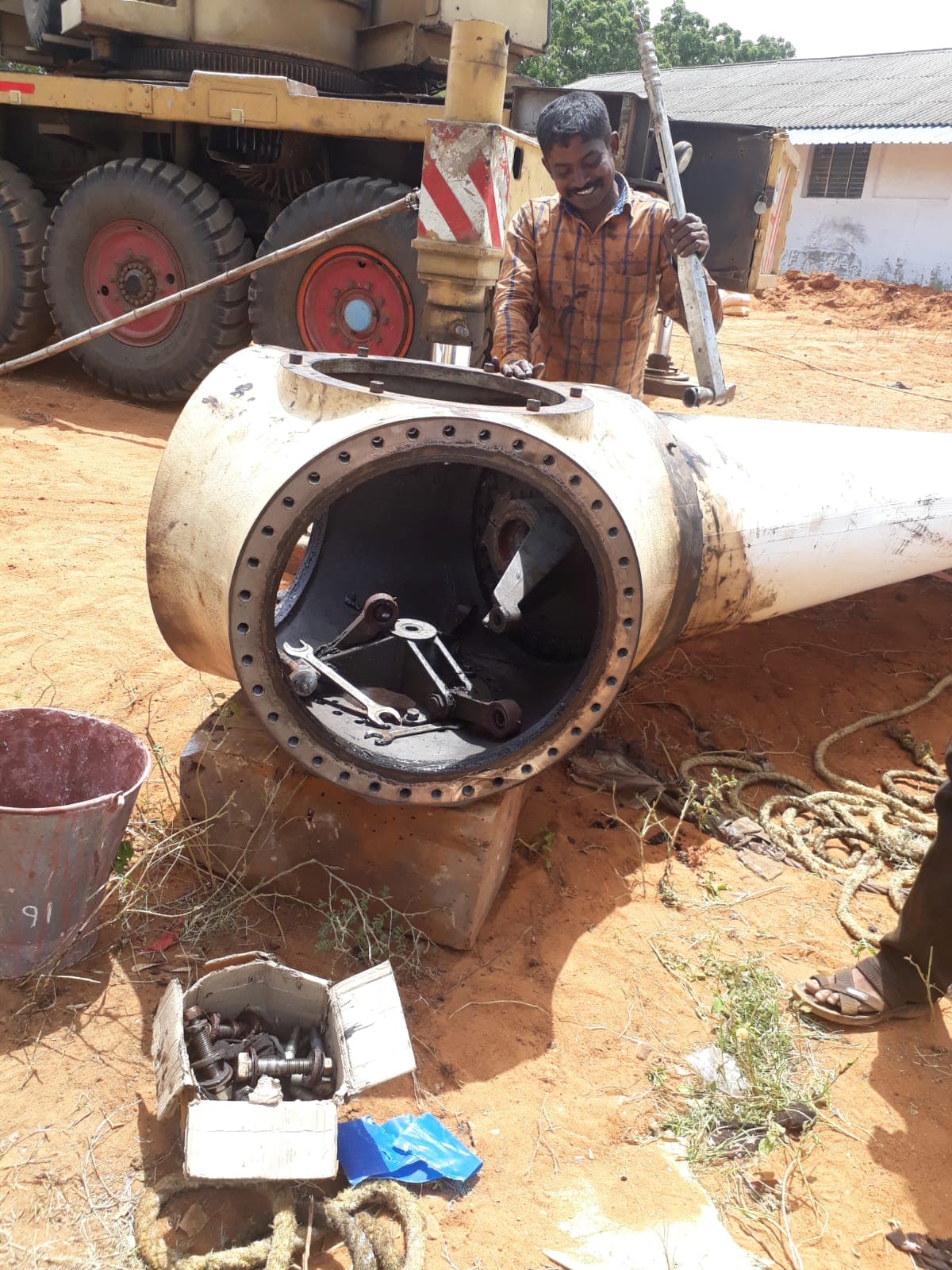 Technician working inside a wind turbine hub during blade patching and repair work