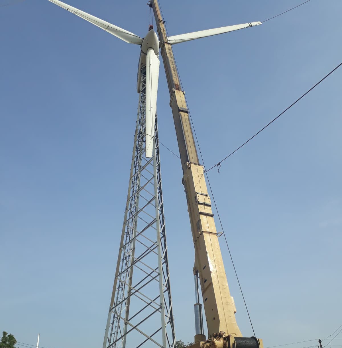 Crane erecting a wind turbine tower and rotor during installation